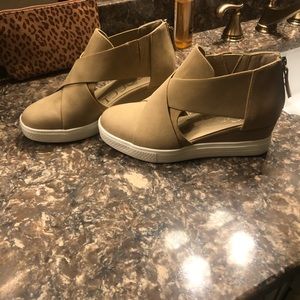 Tan platform cut out sneakers.